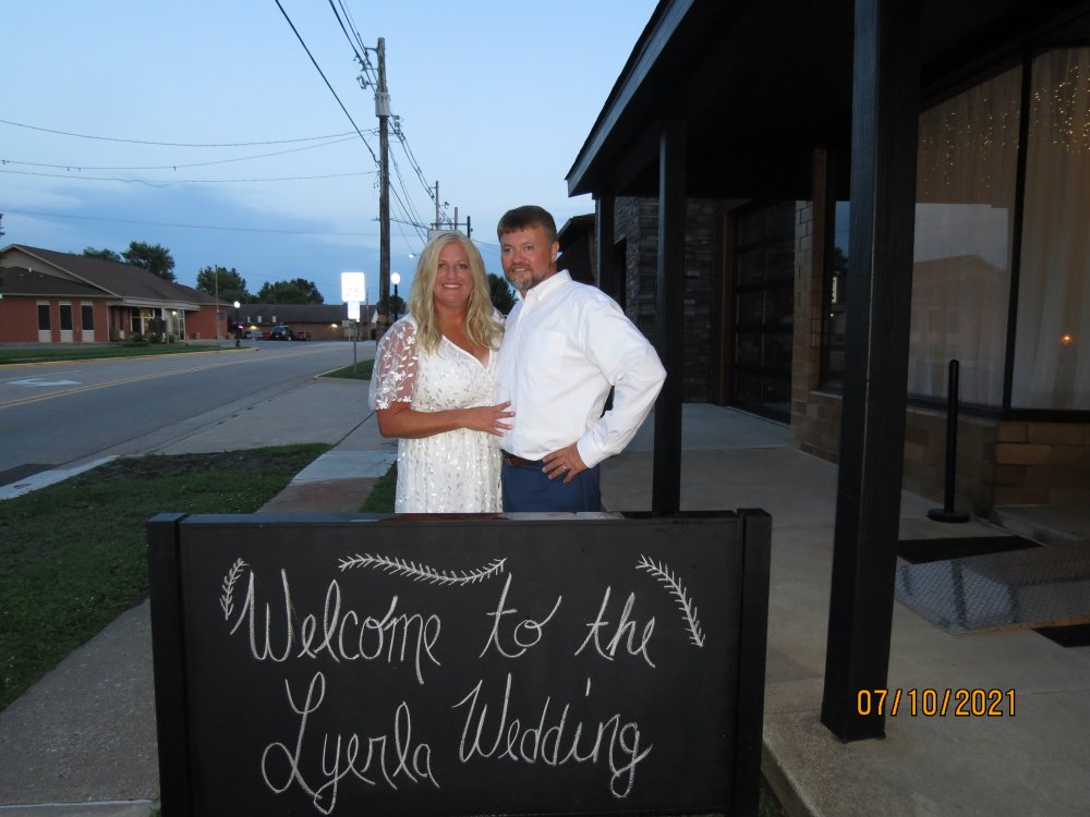 Beth and Frank by Wedding Sign.JPG